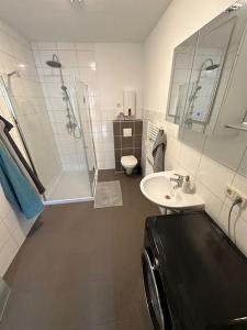 a bathroom with a sink and a shower and a toilet at Villa Emi in Lutherstadt Eisleben