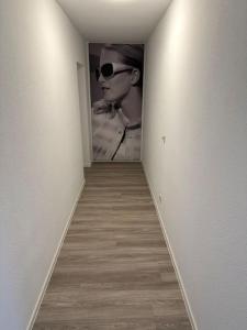 a hallway with a picture of a woman wearing sunglasses at Villa Emi in Lutherstadt Eisleben
