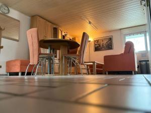 a room with chairs and a table and a dining room at Ostermanns Apartment in Bretten