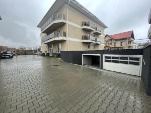 a large apartment building with a parking lot and a driveway at Bella Vista Red Apartment in Braşov