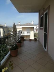 uma varanda de uma casa com vasos de plantas sobre ela em Zeus_Apartment_Ioannina em Neochorópoulon