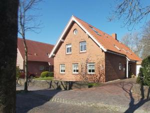 a large brick house with a red roof at Holiday apartment Waterdelle in Borkum
