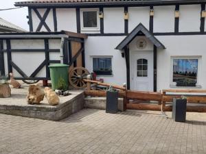 a couple of animals sitting in front of a building at Wellness in the Naafbachtal in Much