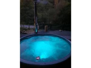 a jacuzzi tub with blue water in a yard at Wellness in the Naafbachtal in Much
