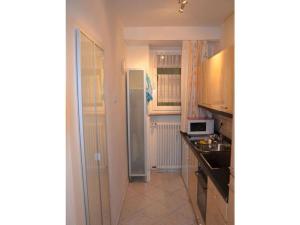 a kitchen with a sink and a refrigerator at Holiday apartment Sonia on the lake in Bad Wiessee +15 photos