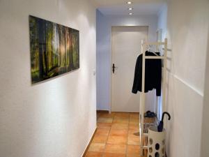 a hallway with a clothes rack and a painting on the wall at Holiday apartment Sonia on the lake in Bad Wiessee