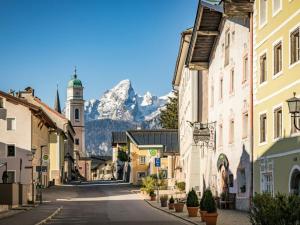 a street in a town with a mountain in the background at Holiday apartment on the slope in Berchtesgaden