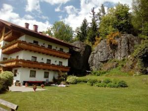 a large building in a yard with a rock at Holiday apartment Sonnenfels I in Bodenmais