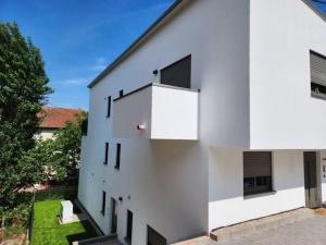a white building with a balcony on the side of it at Holiday apartment ceramics - dreams in Mettlach