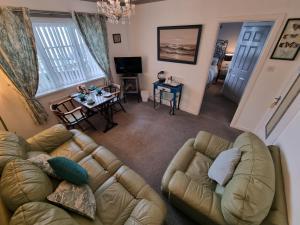 an overhead view of a living room with a couch and a table at The Sup Shack Wellington Inn in New Quay