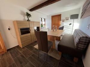 a kitchen with a table and a dining room at Holiday apartment Ebbe in Stedesand