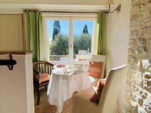 a living room with a table and a window at Holiday Cottage in Provence in Montauroux