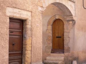 an entrance to a building with a wooden door at Holiday Cottage in Provence in Montauroux +32 photos