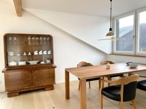 a dining room with a table and a glass cabinet at Holiday apartment Seeloft in Konstanz