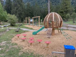a playground with a slide and some mushrooms at Holiday apartment d'griabige in Farchant