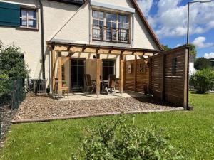 a house with a screened in porch with a patio at Holiday apartment Landzauber in Heideck