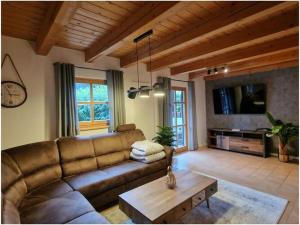 a living room with a couch and a coffee table at Susanne - forest holiday village 