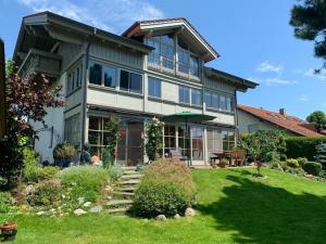 a large house with a lawn in front of it at Holiday apartment Alpenrose in Rieden am Forggensee