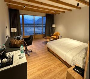 a bedroom with a bed and a living room at Eden Resort Nubra in Hundar