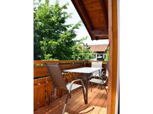 eine Veranda mit einem Tisch und Stühlen auf einer Terrasse in der Unterkunft at Gallus - Wetterstein in Oberstaufen