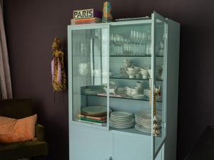 a glass cabinet with plates and dishes in it at Apartment KEMENATE14 in Seeshaupt
