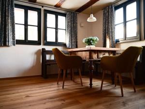 a dining room with a wooden table and chairs at Holiday home time out in the monument in Lohr am Main