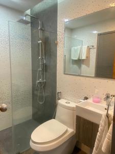 a bathroom with a toilet and a shower and a sink at 8 Hotel & cafe in Bangkok
