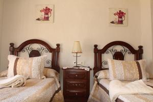 En eller flere senger på et rom på Virgen De Los Remedios