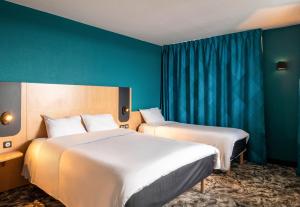 Postel nebo postele na pokoji v ubytování B&B HOTEL Calais Terminal Cité Europe 3 étoiles + 28 fotografií