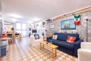 a living room with a blue couch and a table at Marinautica Sea Cottage in Sorrento