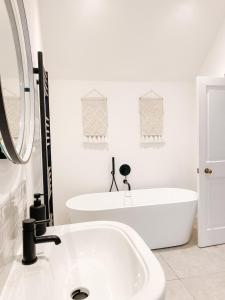 a white bathroom with a tub and a sink at The Annexe - KG Retreats in Ketton