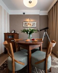 a dining room with a table and chairs and a lamp at Hotel Esperanto in Białystok