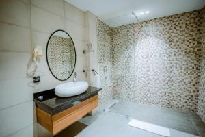 a bathroom with a sink and a mirror at TIMAZIN HOTEL DAKHLA in Dakhla