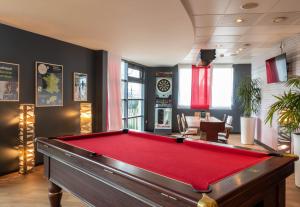 a billiard room with a red pool table at B&B HOTEL Calais Terminal Cité Europe 3 étoiles in Coquelles