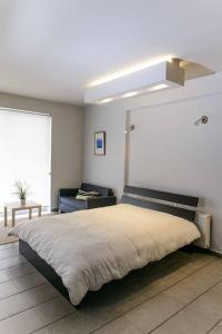 a bedroom with a large bed with a white ceiling at Luxury Flat Cosy Bright in Gazi Kerameikos Metro in Athens