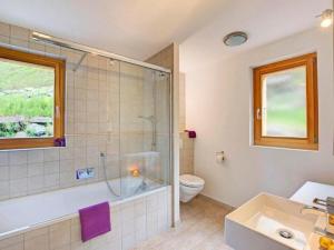 a bathroom with a shower and a toilet and a sink at Chalet Bryher in Les Collons