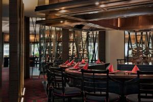 a dining room with a long table and chairs at Anantara Riverside Bangkok Resort in Bangkok
