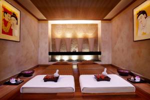 a meditation room with two meditation benches in front of a fireplace at Anantara Riverside Bangkok Resort in Bangkok