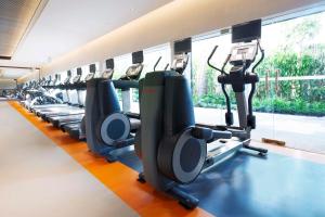 a row of tread machines in a gym at Anantara Riverside Bangkok Resort in Bangkok