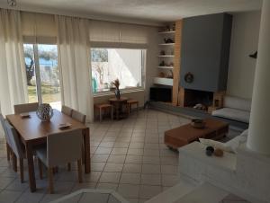 a living room with a table and a dining room at V.K.Seaside Villa in Volos