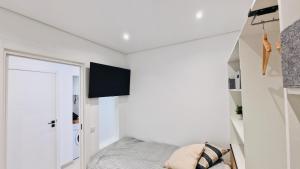 a small bedroom with a bed and a closet at Your dream Getaway Awaits in Vale do Lobo in Almancil