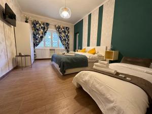 a bedroom with two beds and a large window at Il Giardino a Monte Sacro in Rome