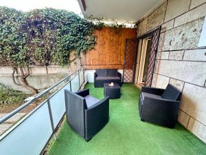 a balcony with two chairs and a table on grass at Il Giardino a Monte Sacro in Rome