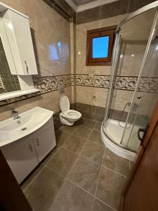 a bathroom with a shower and a toilet and a sink at ÖZTÜRK Apart in Trabzon