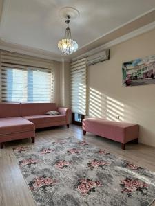 a living room with two pink couches and a rug at ÖZTÜRK Apart in Trabzon