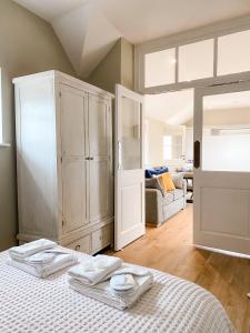 a bedroom with a bed with two towels on it at The Annexe - KG Retreats in Ketton