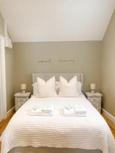 a bedroom with a large bed with two night stands at The Annexe - KG Retreats in Ketton