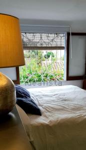a bedroom with a large bed and a window at Barrio Andaluz apartment in Almuñécar