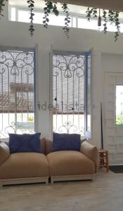 a living room with a couch and two windows at Barrio Andaluz apartment in Almuñécar