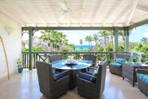 a patio with a table and chairs and the ocean at Beacon Hill 304 by BSL Rentals in Saint Peter